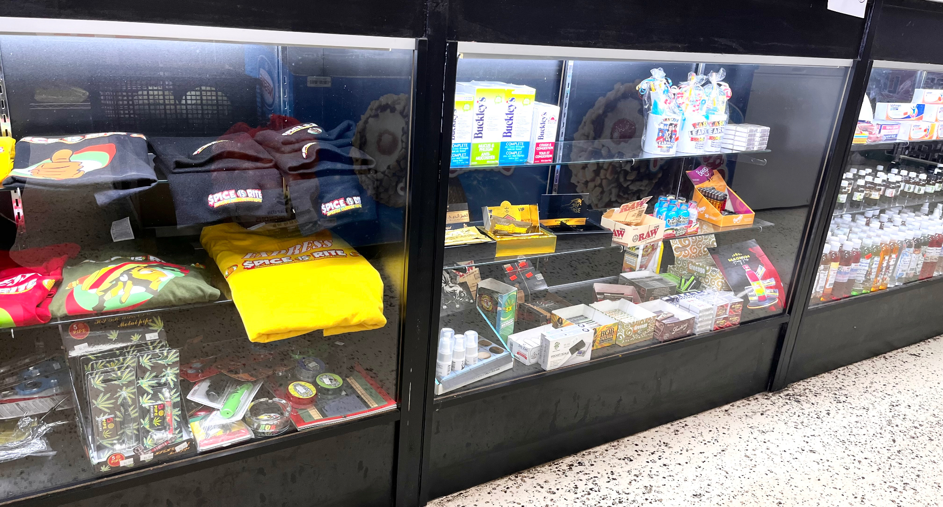 Display case with branded Spice Is Rite apparel and store merchandise